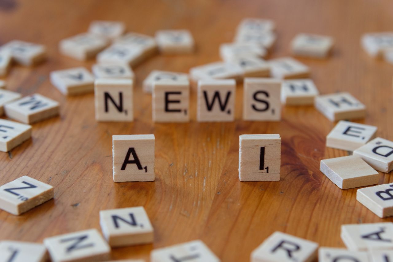 services-02 Wooden Scrabble tiles spelling 'AI' and 'NEWS' for a tech concept image.